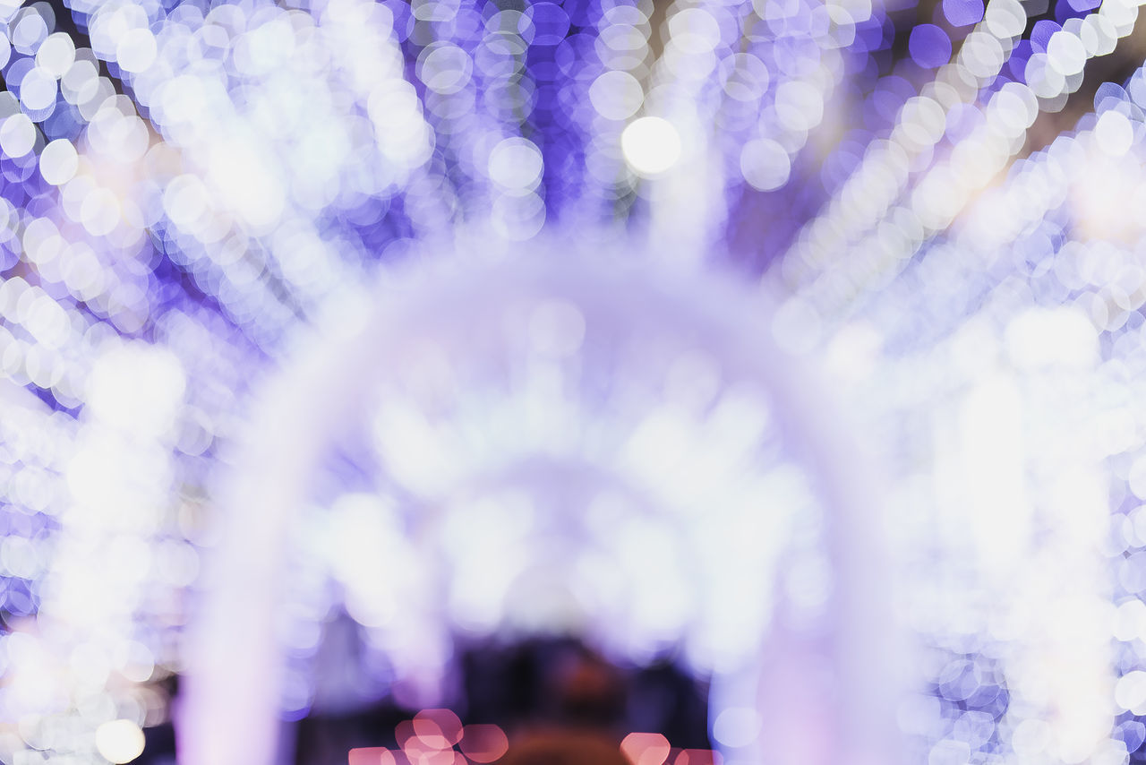 DEFOCUSED IMAGE OF ILLUMINATED LIGHTS