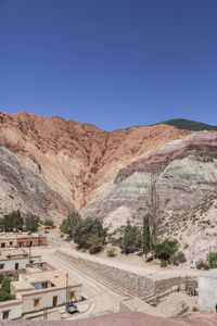 Scenic view of mountain against blue sky