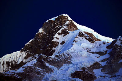 View of snowcapped mountain peak against clear sky