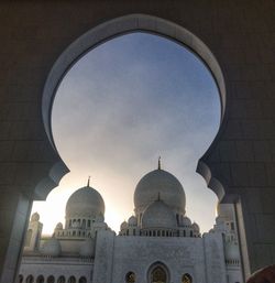 Low angle view of mosque seen through arch