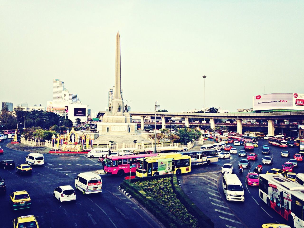 transportation, car, land vehicle, mode of transport, road, street, city, road marking, traffic, clear sky, architecture, built structure, on the move, building exterior, city life, copy space, travel, city street, high angle view, vehicle