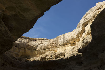 Low angle view of rock formations against sky