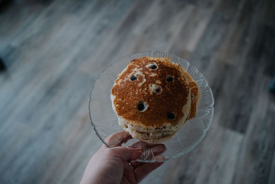 Overhead of a person holding a plate of pancakes