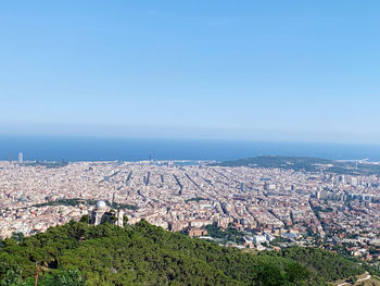 High angle view of townscape against clear blue sky