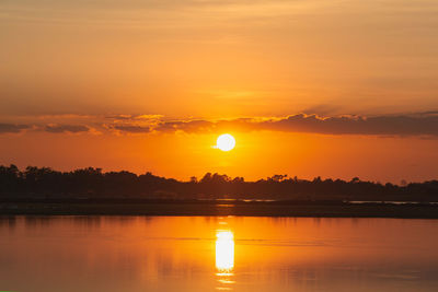 Scenic view of lake against romantic sky at sunset