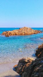 Scenic view of sea against clear blue sky