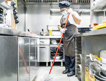 Cook scrubbing the kitchen after cooking