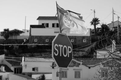 Close-up of road sign against buildings in city