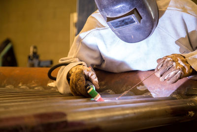 Man welding metal at workshop