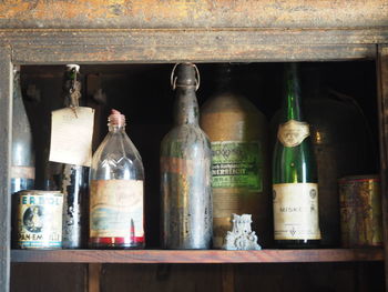 Close-up of beer bottles in shelf