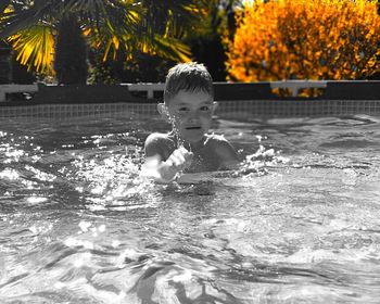 Portrait of boy swimming in pool