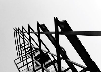 Low angle view of silhouette construction against clear sky