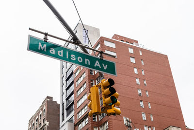 Low angle view of road sign against buildings