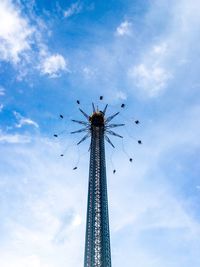 Low angle view of chain swing ride against sky