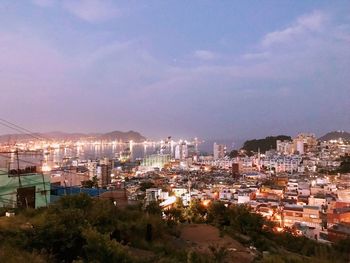 High angle view of illuminated buildings against sky