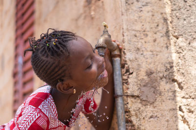 Portrait of girl against wall