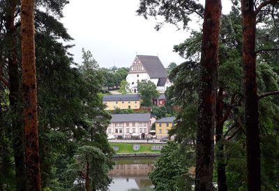 Panoramic view of trees and buildings against sky