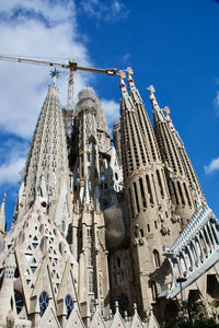 Low angle view of sagrada familia against blue sky