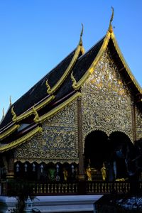 Low angle view of temple building against clear blue sky