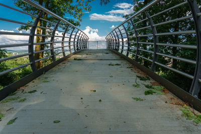 Footbridge over water against sky