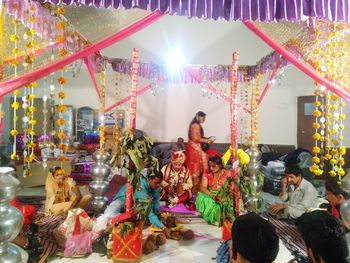 Group of people at illuminated market stall