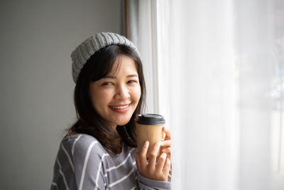 Portrait of young woman drinking coffee