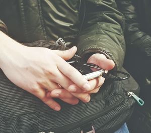 Close-up of man holding mobile phone