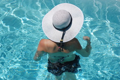 High angle view of young woman in swimming pool