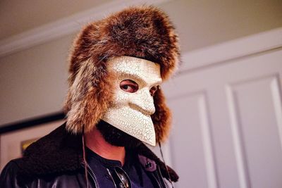 Portrait of man wearing mask at home
