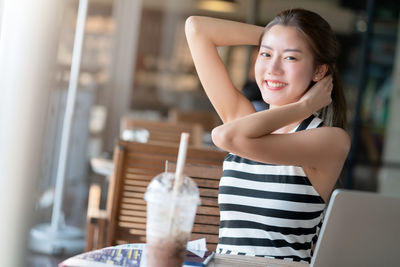 Portrait of a smiling young woman holding ice cream