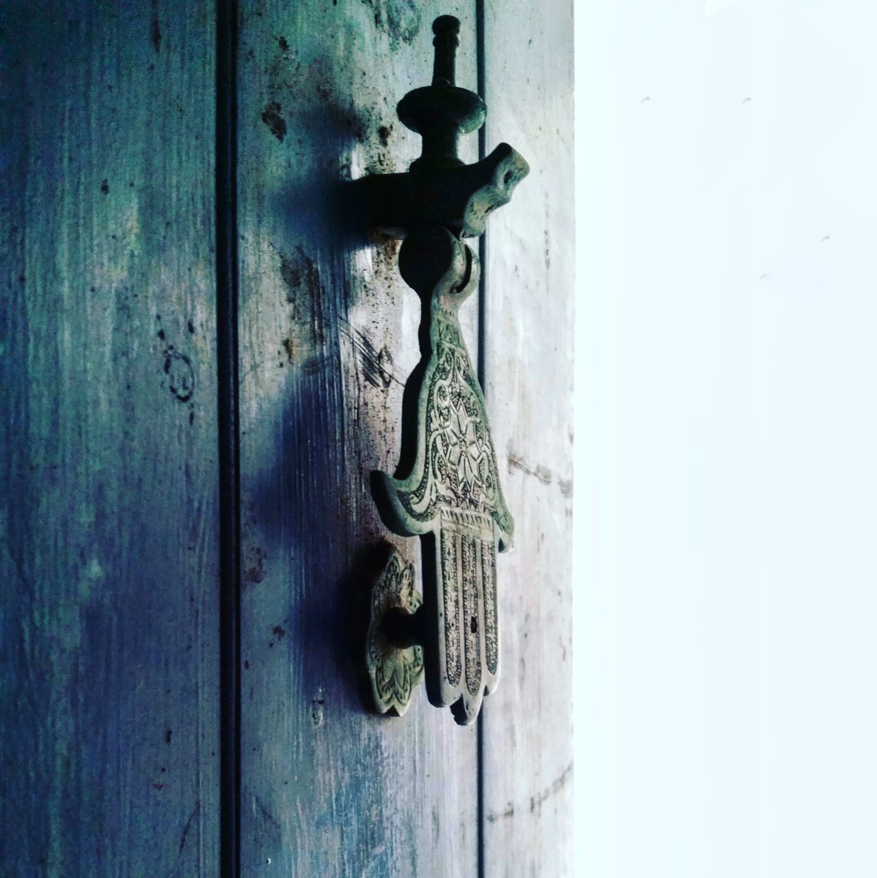 CLOSE-UP OF DOOR HANGING ON WOODEN WALL