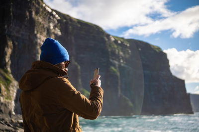 Midsection of man in mountains against sky