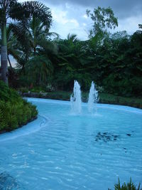 Scenic view of waterfall against sky