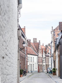 Street amidst buildings in town against sky