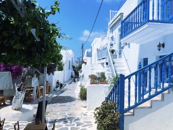 Blue and white buildings by narrow footpath at mykonos