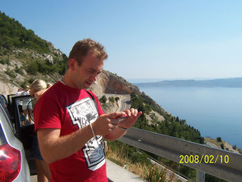 Scenic view of sea with mountain in background