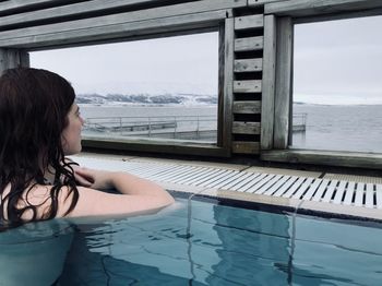 A woman enjoying the view in icelandic natural spring pool, in laugarvatn fontana, iceland