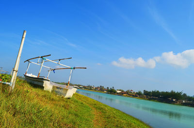 Windmills by swimming pool against sky