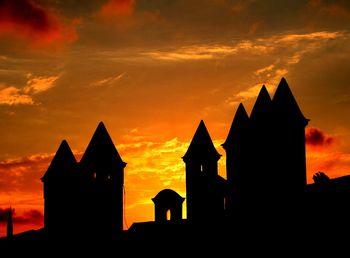 Low angle view of silhouette buildings against sky during sunset