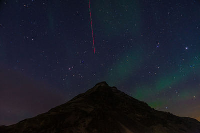 Low angle view of mountain against sky at night