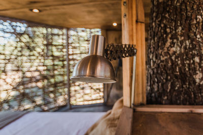 Close-up of illuminated pendant light hanging on wall