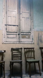 Empty wooden chairs in empty room