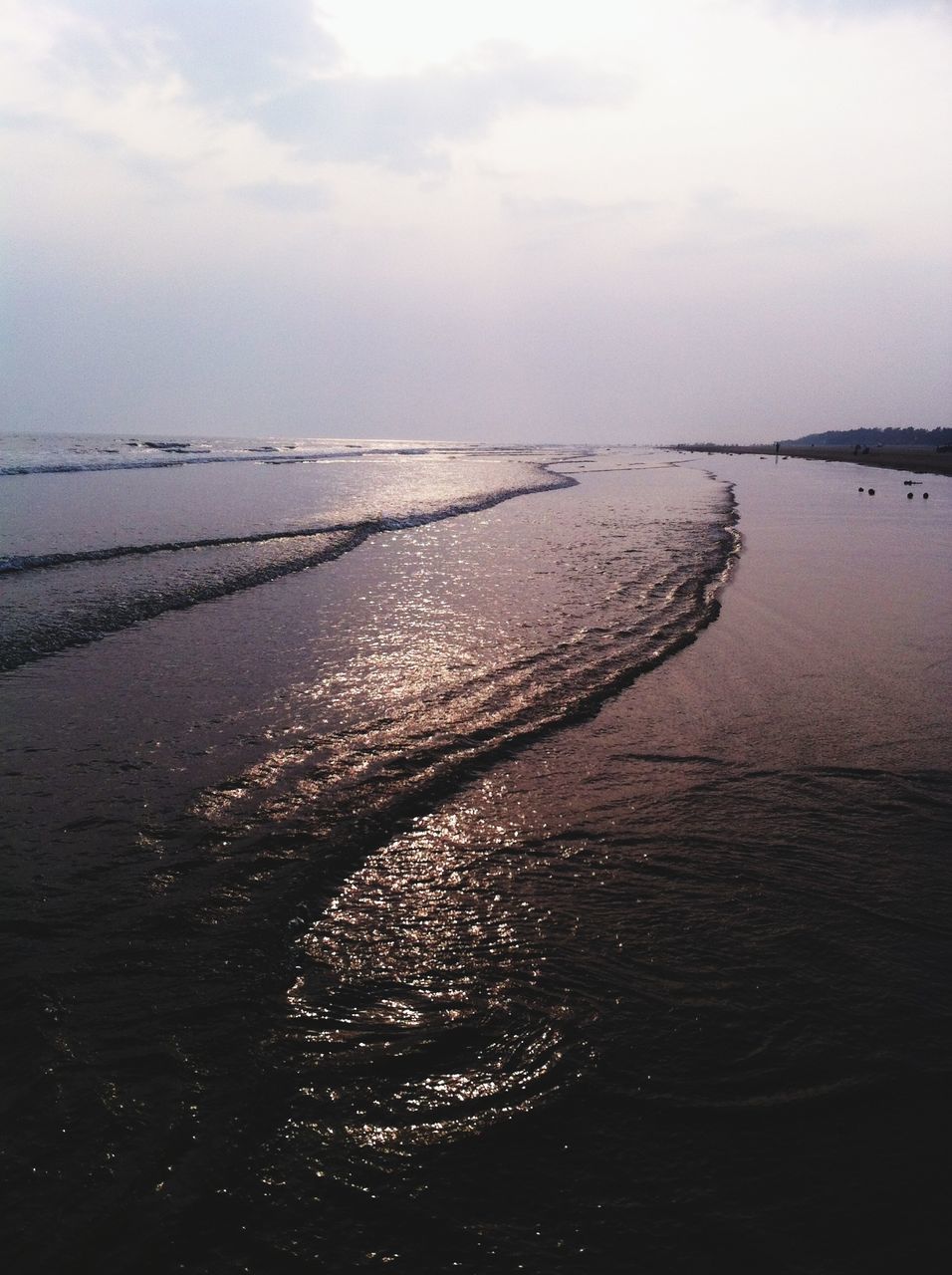 VIEW OF CALM BEACH AGAINST SKY