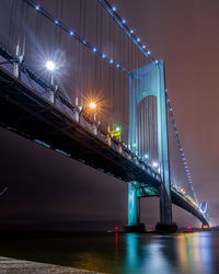 Low angle view of suspension bridge at night