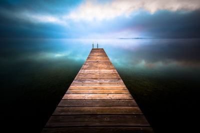 Pier over sea against sky