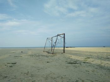 Lifeguard hut on beach against sky