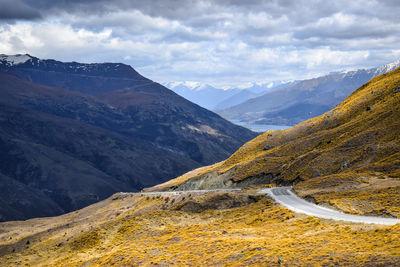 Scenic view of mountains against cloudy sky