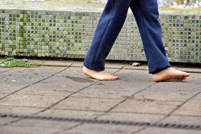 Low section of man standing on footpath