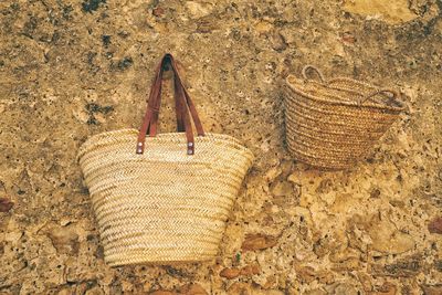 Wicker baskets hanging from stone wall