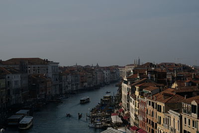 High angle view of buildings by canal against sky